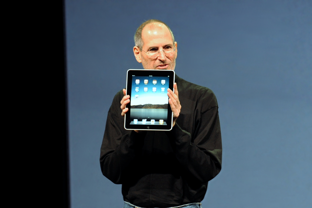 Steve Jobs presenting an iPad.