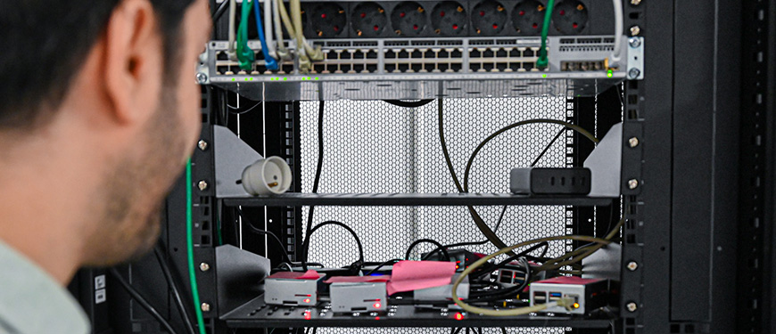Researcher by a server cabinet