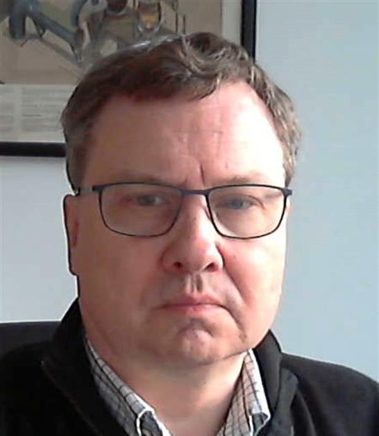 Portrait of Knud Villy Christensen Head-and-shoulders portrait of Knud Villy Christensen wearing glasses and a dark jacket indoors.