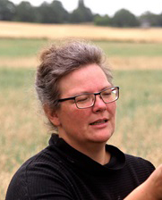 Sara Egemose outdoors in a field Sara Egemose wearing glasses outdoors in front of a field.