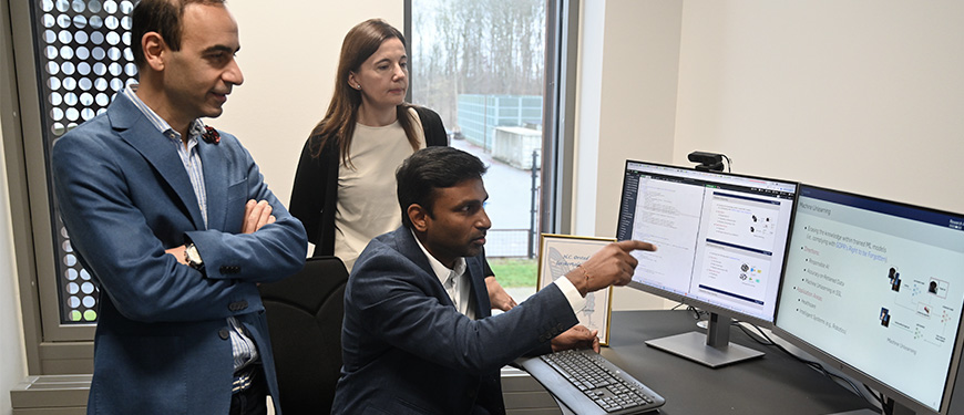 Researchers pointing at monitors