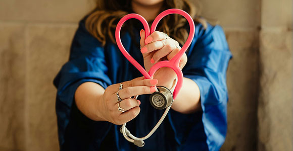 Woman with a stethoscope shaped like a heart