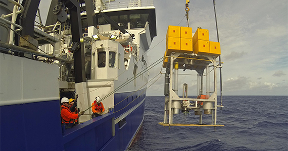 Equipment for deep sea research is being lowered over the side of research vessel.