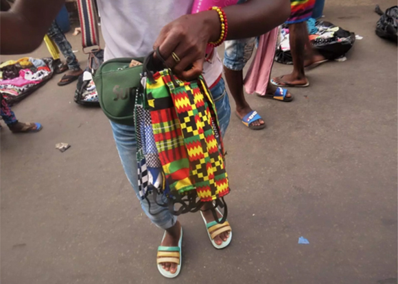 Image of a local produced mask held in the hand of a Sierra Leone resident.