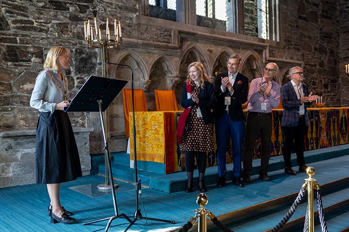 Professor Åslaug Ommundsen on stage alongside Tuomas Heikkilä, Lars Boje Mortensen and Matthew Collins.Photo:  Eivind Senneset