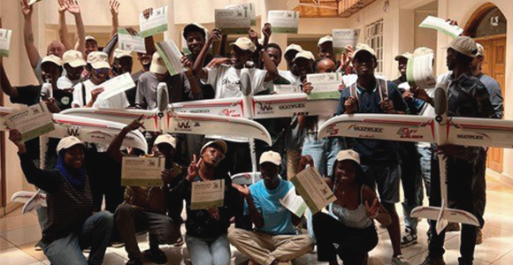 Group of studens with fixed wing drones