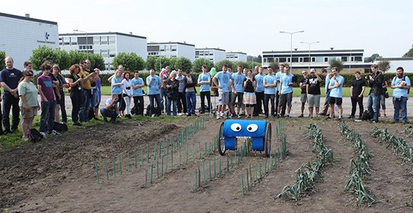 Agricultural robot in test field with students