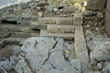 Fig. 18. Sector 2. View to the west. Remains of a large, massive foundation constructed of strong slabs of green andesite. The foundation originally continued across the levelled rock in the foreground.