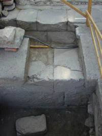 Fig. 24. Excavation under the ramp nrth of the Chapel. View to the east. In the foreground the facade of the great terrace wall is seen and immediately behind this wall constituing the western border of the large platform in sector 2.
