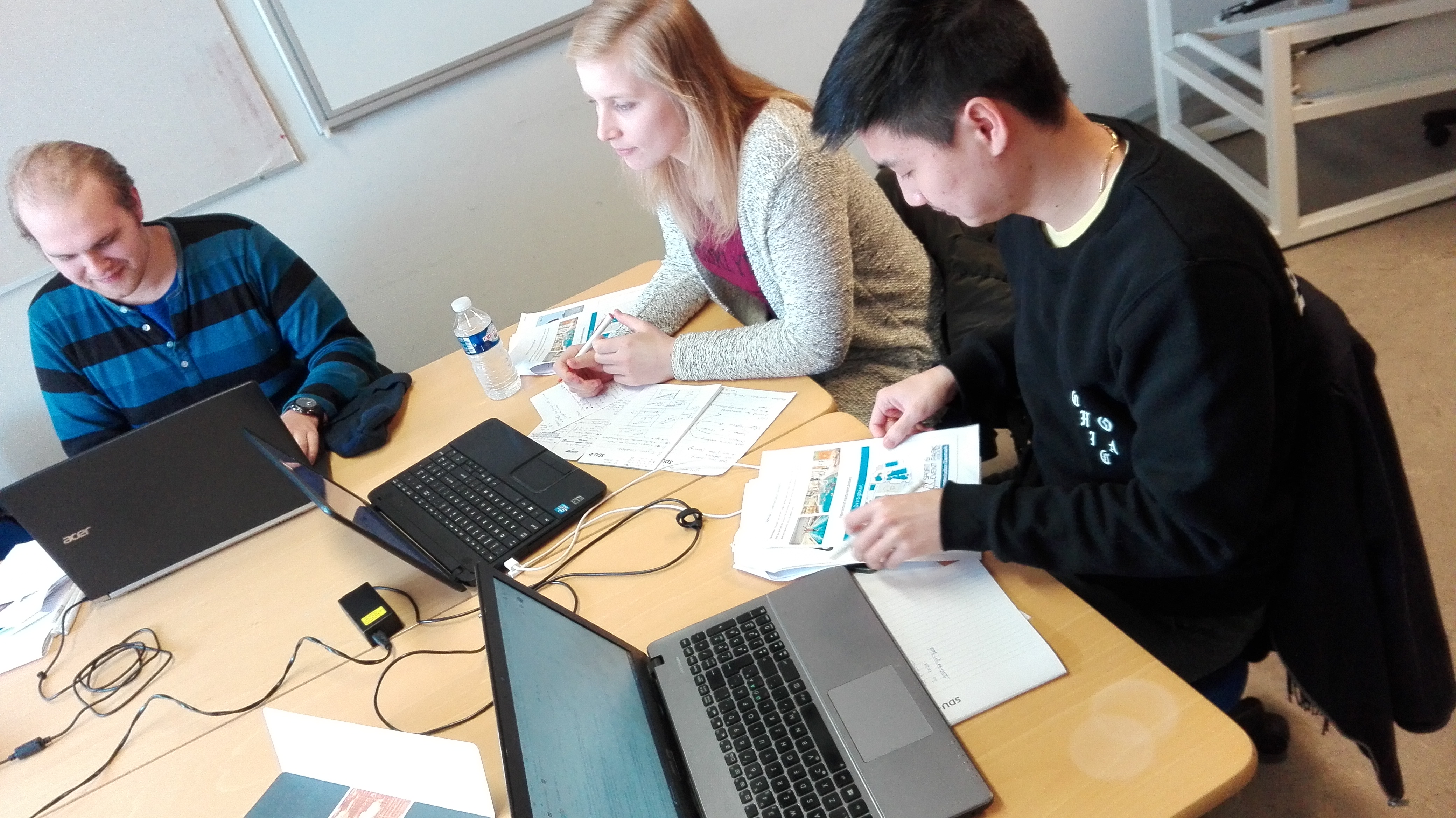 Martin, Anika and Hung working on the case
