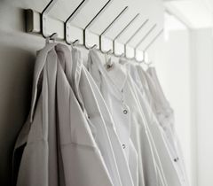 lab coats hanging on rack