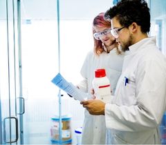 two scientists in lab reading