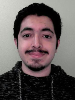 Head-and-shoulders portrait of Reza Piri facing the camera against a plain light-colored wall.