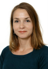 Head-and-shoulders studio portrait of a woman with shoulder-length brown hair wearing a dark teal top.