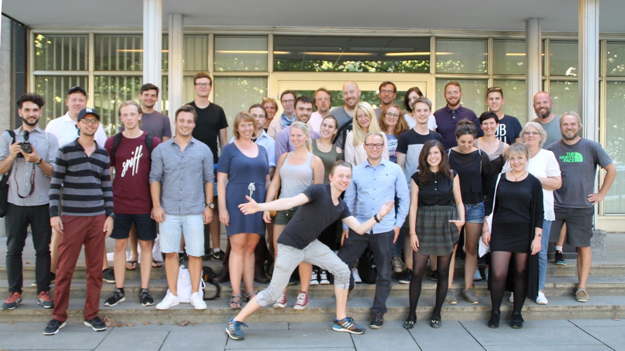 Group photo of Spice Camp 2016 participants standing on outdoor steps in front of a building, with one person posing playfully in the foreground.