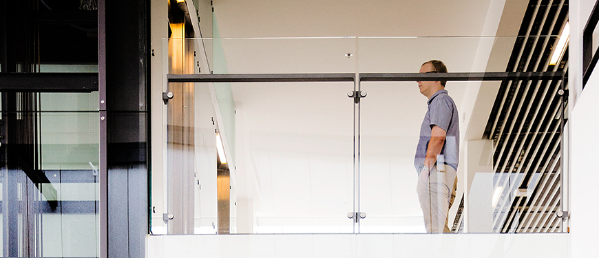 Employee standing in front of the elevator.