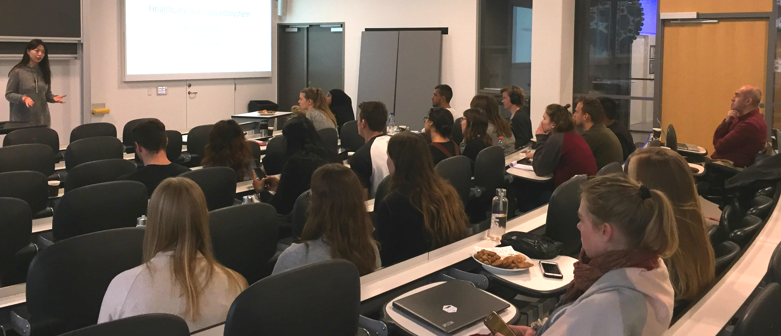 Students listening to researchers presentation