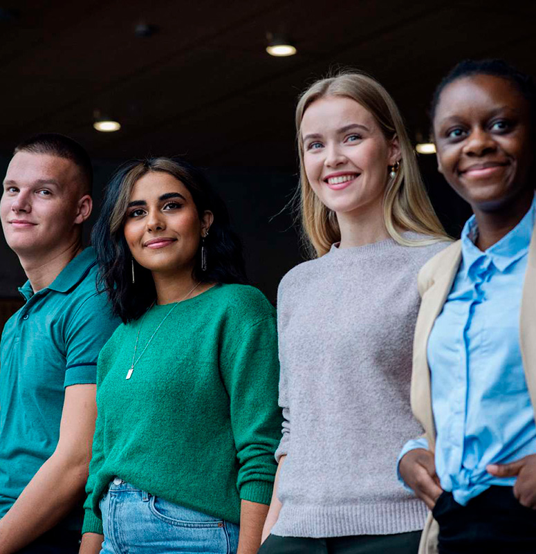Four SDU students standing side by side, wearing casual and professional attire.