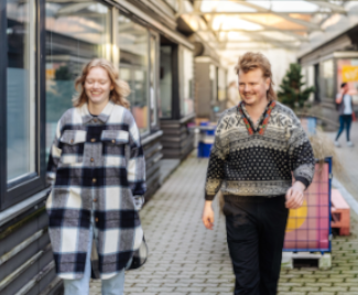 Indoor courtyard with people walking by.