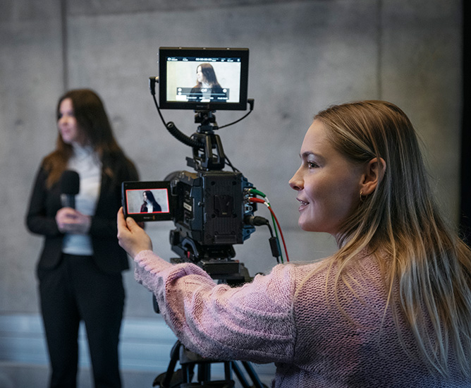 Studerende på campustorvet med kamera